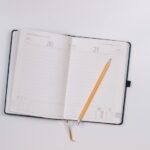 pencil on opened notebook